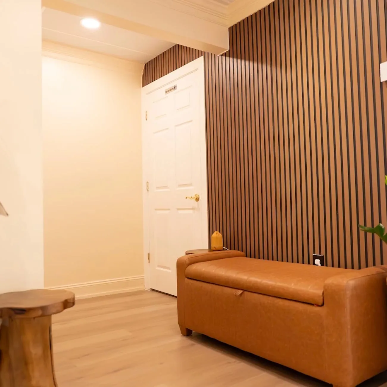The waiting lounge at Organic Day Spa, with a velvet bench, soft lamplight and a tea tray